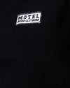 Nero con etichetta Motel Work