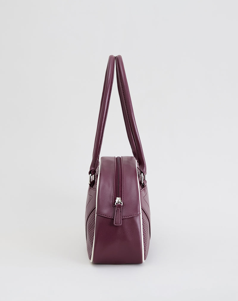 Immagine della borsa bowler in crema e borgogna
