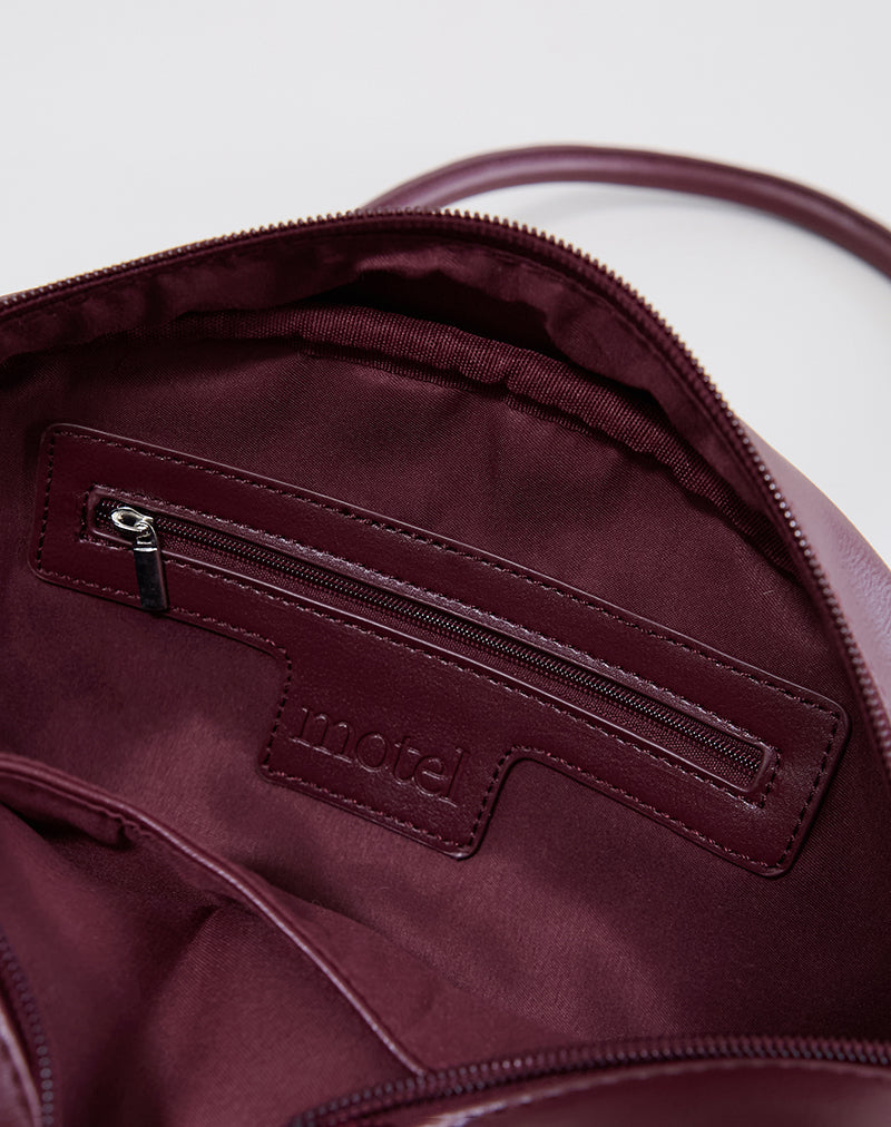 Immagine della borsa bowler in crema e borgogna