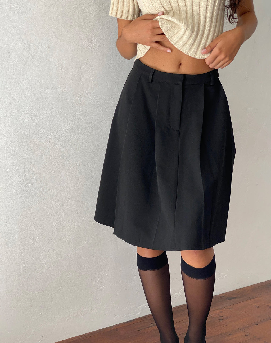 Gonna a pieghe al ginocchio Colette in nero Sartoria