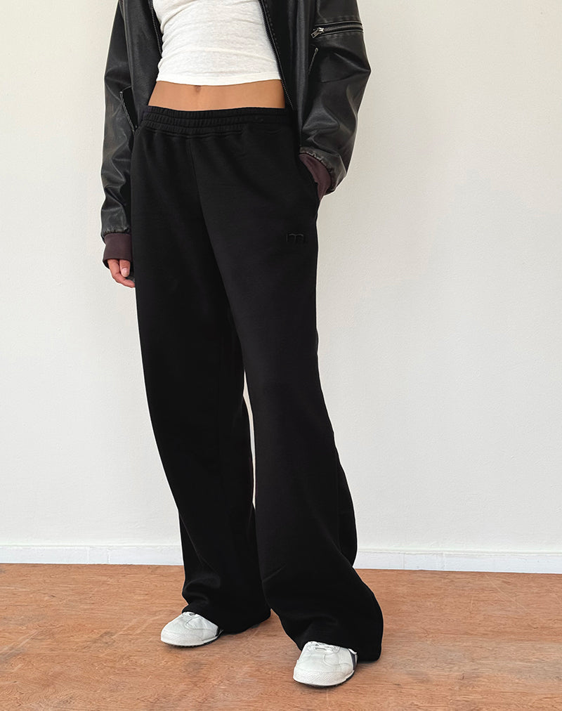 Jogger sciolti in nero con ricamo "M
