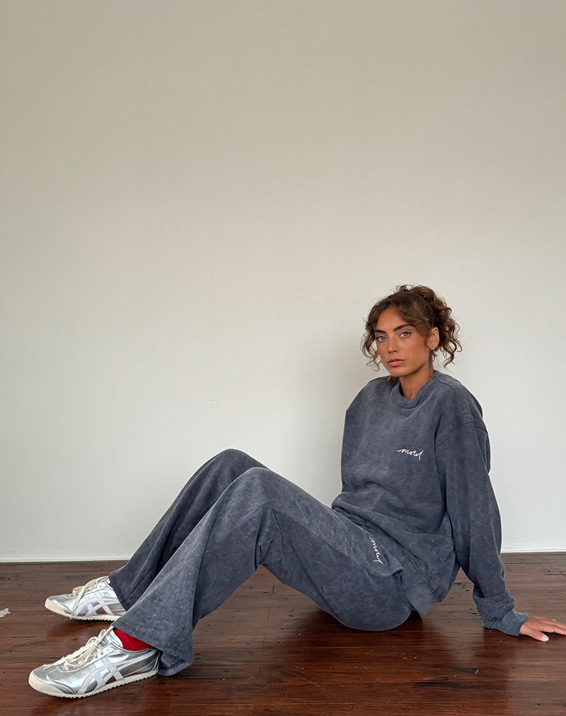 Jogger larghi in lavaggio nero con ricamo 'MOTEL' in bianco sporco