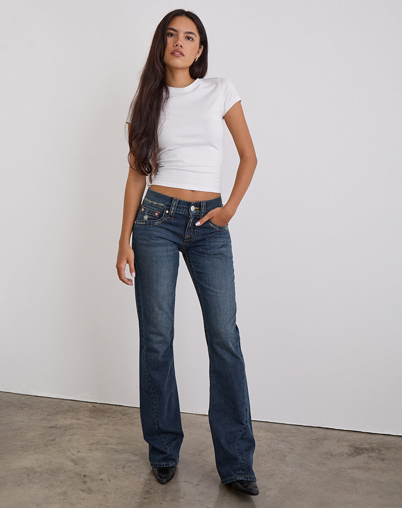 Jeans a vita bassa con cuciture ritorte in tinta blu medio