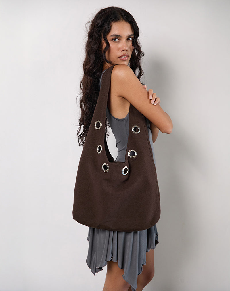 Borsa a tracolla Oru in marrone con occhielli