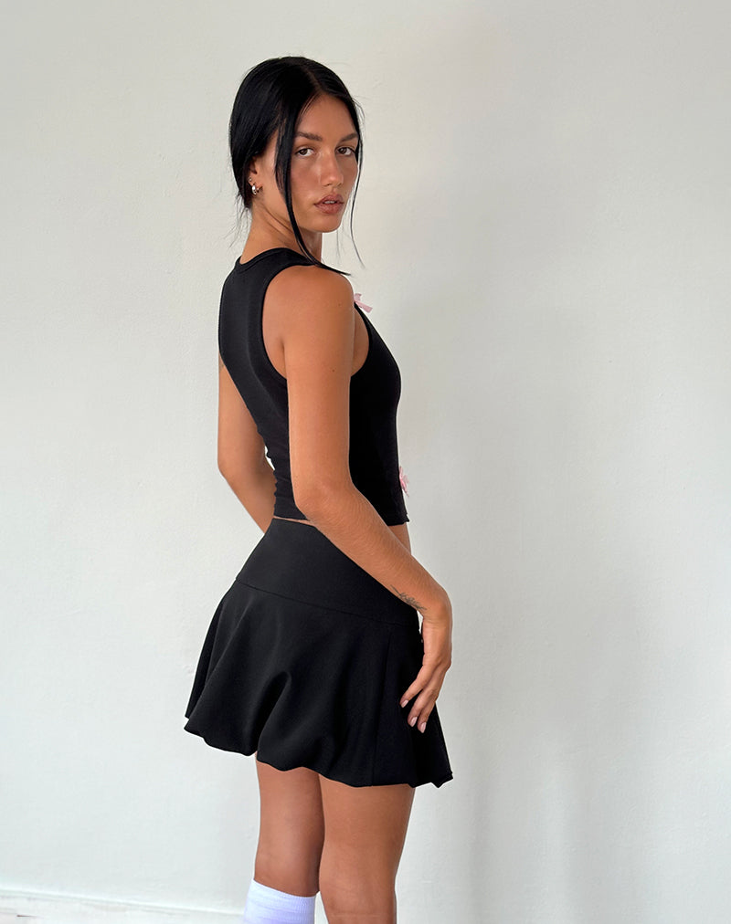 Immagine della canotta Rave in nero con fiocchi rosa