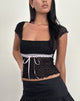 Immagine di Sherine Top in pizzo nero con nastro rosa