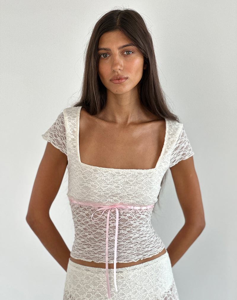 Immagine di Sherine - Top in pizzo color crema con rilegatura rosa