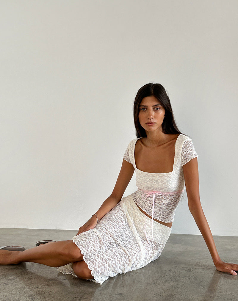 Immagine di Sherine - Top in pizzo color crema con rilegatura rosa