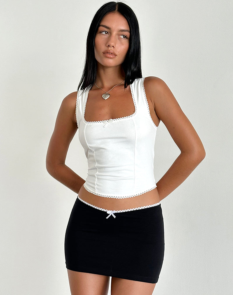 Minigonna Vadia in nero con fiocco e bordi in picot bianco