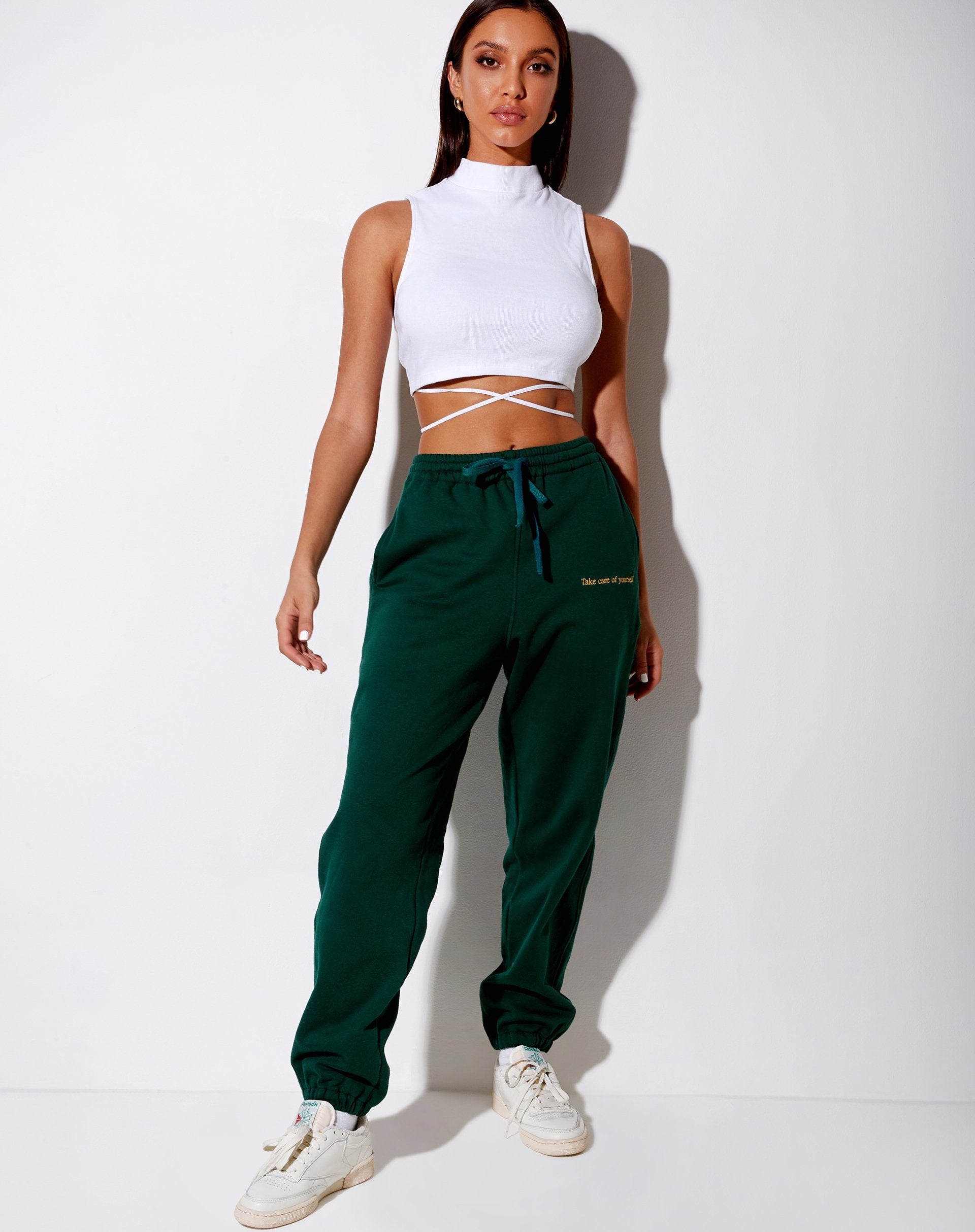 Immagine di Basta Jogger in verde bottiglia con ricamo Take Care Of Yourself